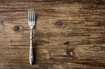 Dining fork on vintage wooden table