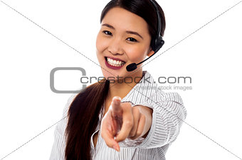 Call centre support staff pointing towards camera