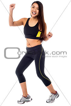 Cheerful fitness trainer dancing in joy