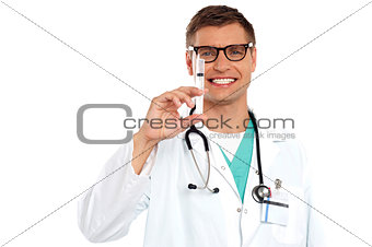 Doctor with an injection needle with white fluid