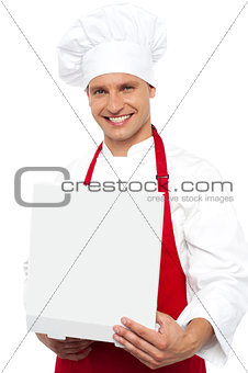 Portrait of a chef holding a pastry box