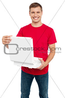 Smiling casual man holding pizza box