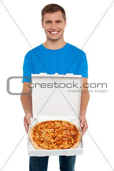 Smiling man offering pizza to you