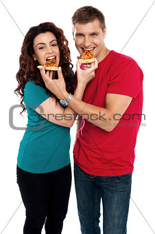 Adorable love couple enjoying pizza pie together