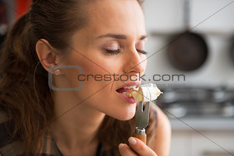 Portrait of young woman eating camembert