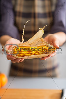 Closeup on young housewife showing corn