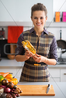 Portrait of happy young housewife with corn