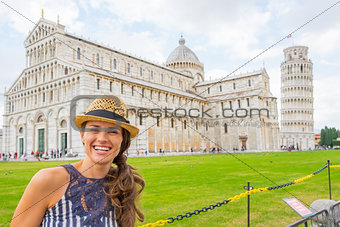 Portrait of happy young woman on piazza dei miracoli, pisa, tusc