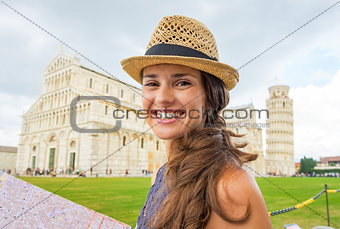 Portrait of happy young woman with map on piazza dei miracoli, p