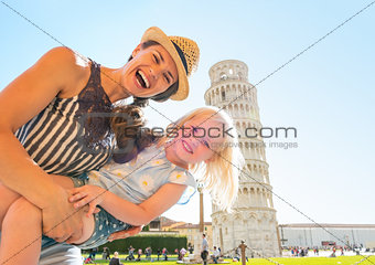 Portrait of mother and baby girl in front of leaning tower of pi
