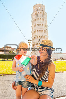 Portrait of mother and baby girl with italian flag in front of l
