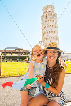 Portrait of smiling mother and baby girl with italian flag in fr
