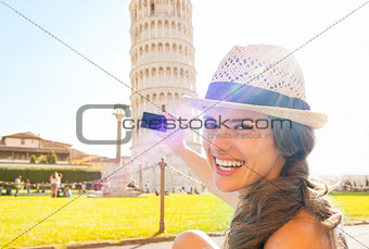 Happy young woman taking photo of leaning tower of pisa, tuscany