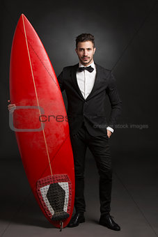 Latino young man with a surf board