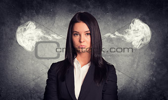 Sad woman with steam from ears. Concrete gray as backdrop