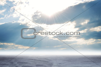 Concrete floor on background of clouds, sun 