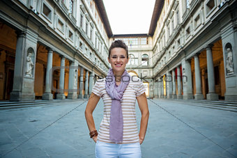 Portrait of smiling young woman near uffizi gallery in florence,