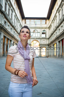 Young woman near uffizi gallery looking into distance in florenc