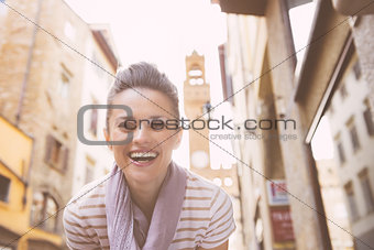 Portrait of smiling young woman not far from palazzo vecchio, in