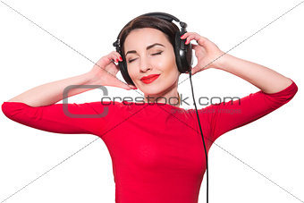 Attractive young adult woman in red clothes listening to the mus