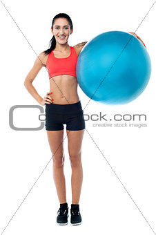 Fitness trainer holding pilates ball