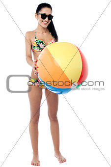 Bikini woman holding colorful ball