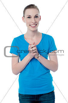 Happy young girl with clasped hands