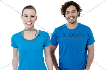 Couple in blue t-shirts. Isolated over white.