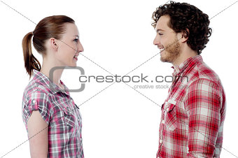 Casual young couple facing each other