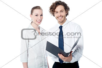 Office colleagues reviewing business file
