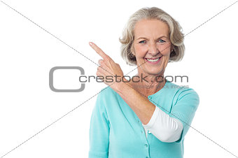 Pretty aged woman pointing at something