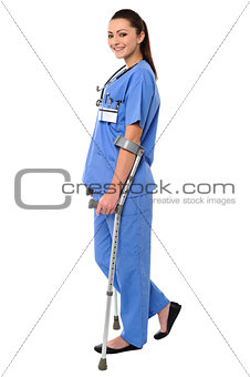 Lady doctor walking with help of crutches