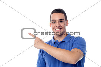 Cheerful teenager pointing away