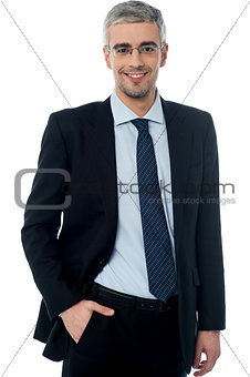 Business man smiling, hand in pocket