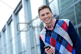 Handsome young man listening to music