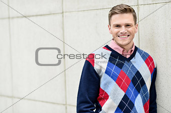 Young man leaning relaxed against the wall