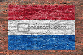 Flag of Netherlands painted over brick wall