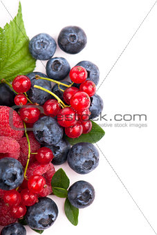 Many blueberries, raspberries. Isolated white
