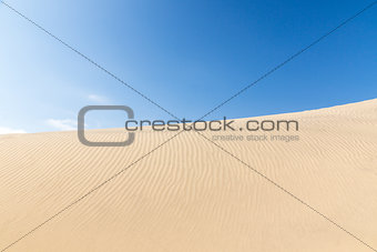 Blue sky and sand dunes. Sunny day. 