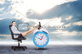 Woman in jacket and skirt sitting on chair. Background of the ro