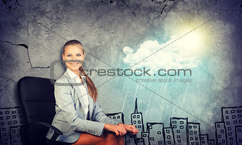 Woman in jacket holding clipboard and looking at camera. Background sketch of houses, sun, rain, cloud