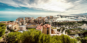 Picturesque view of Malaga bullring (La Malagueta) and seaport. 