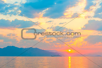 passenger ship on the sea and a beautiful sunrise