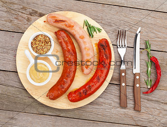 Various grilled sausages with condiments 