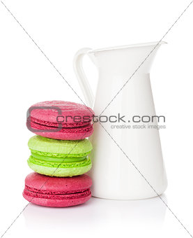 Colorful macarons and milk jug