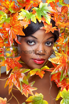 Beautiful young woman wrapped in leafs