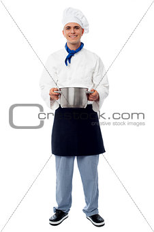 Male chef holding a steel saucepan