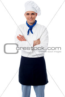 Confident young chef with arms crossed
