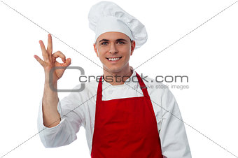 Smiling male chef showing ok sign