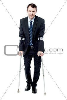 Smart man with crutches trying to walk